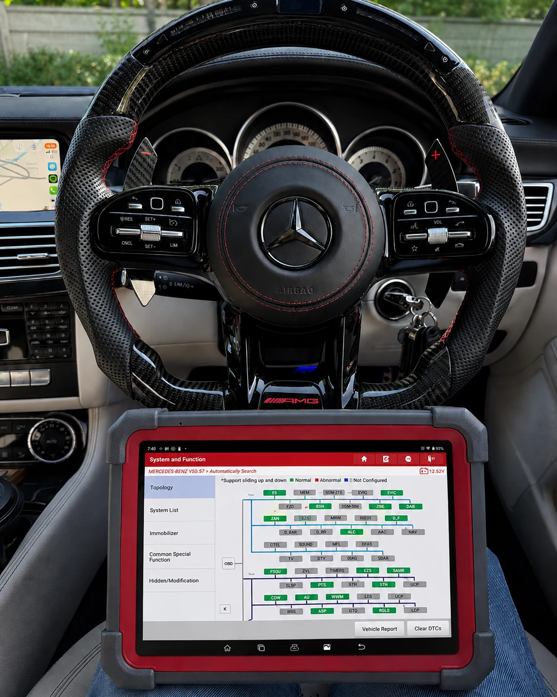 Strong Scan professional vehicle diagnostics with a diagnostic tablet inside a vehicle